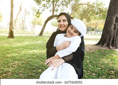 Happy Emirati Mother With Child. Day Time With Arab Mom With Arabic Son. Emarat Woman On Abaya And Young Boy On Kandura Dish Dash