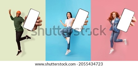 Happy emotional successful international people expressive emotions of joy, show smartphone with empty screen, isolated on colored background. Advertising, app, huge offer and sale, social networks