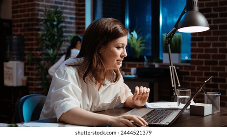 Happy employee reading email on laptop received from customer, excited after managing to secure lucrative deal for company. Businesswoman celebrating finalizing agreement with client, camera A