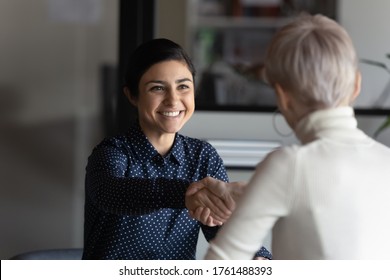 Happy employer HR manager shaking hands with indian job seeker welcoming vacancy applicant. Successful manager making deal with partner, good positive first impression, start business meeting concept - Shutterstock ID 1761488393