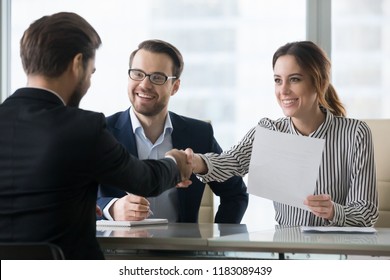 Happy employers shake hand of male job candidate, congratulating with given position, satisfied HR managers happy to hire applicant handshake greeting at team. Successful good interview concept - Shutterstock ID 1183089439