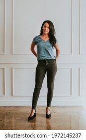 Happy Empowering Black Woman Standing By A White Wall