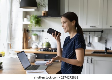 Happy Engaged Young Freelance Employee Woman Making Telephone Call, Talking On Speaker, Using Virtual Voice Assistant, Giving Vocal Command To Online App, Recording Audio Message