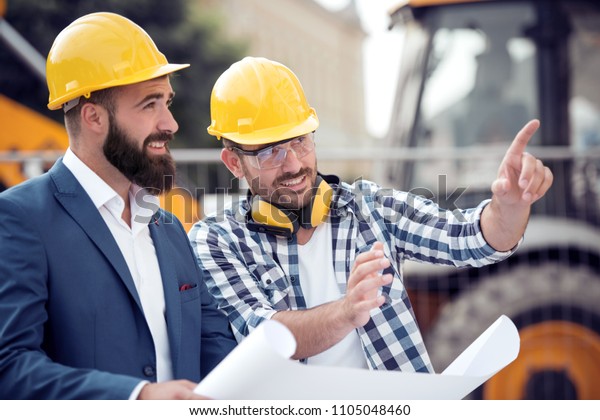 Happy Engineer Discussing Colleague Construction Site Stock Photo ...