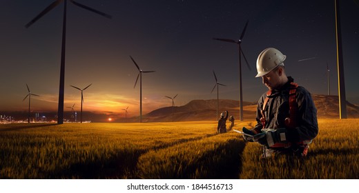 Happy engineer feel success after good work. He standing and looking beautiful sunset landscape. High quality photo