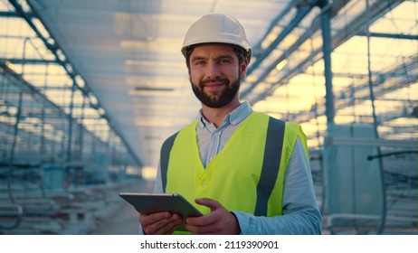 Happy engineer with tablet collecting production data analysing efficiency. Hardworking handsome manufacture supervisor checking factory safety using digital device. Modern manufacturing concept - Shutterstock ID 2119390901
