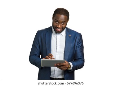 Happy Entrepreneur With Digital Tablet. Smiling Young Businessman Working At Portable Computer Tablet And Looking Straight. Project Manager Working On Touch Screen Computer.