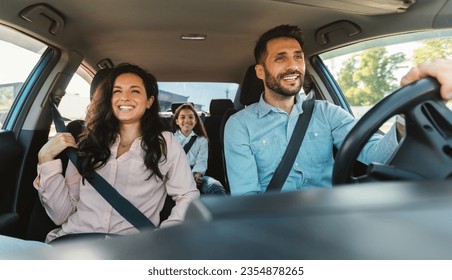 Happy european family of three riding car, traveling by automobile together, parents and daughter enjoying road trip on weekend, panorama
