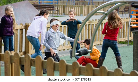 Happy european kids playing at Dead man in street