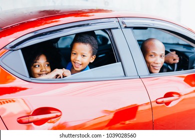 Happy And Excited African American Family Taking A Road Trip With Their Car - Happy Family Togetherness Concept