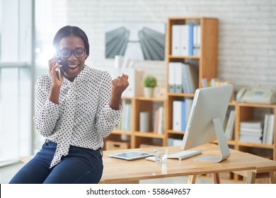 Happy and excited African-American business woman