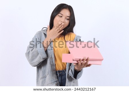 Happy excited, Asian young woman opening gift box isolated on white background. Receiving gifts from lovers. Anniversary, valentine New Year or Christmas concept