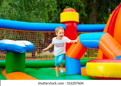 happy excited boy having fun on inflatable attraction playground - Shutterstock ID 316207604