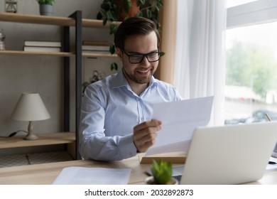 Happy excited business man reading received paper letter, loan document from bank, paid back mortgage notice, professional certificate. Student getting admission from school, college