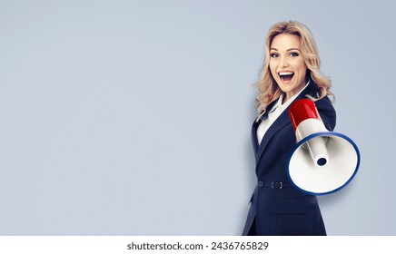 Happy excited business woman, hold megaphone mega phone bullhorn loud speaker shout advertise sale ad offer. Businesswoman use loudspeaker bull horn, isolated against grey wall plain background. - Powered by Shutterstock