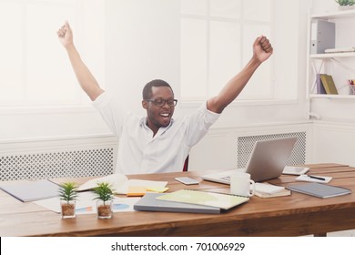 Happy Excited Businessman Celebrate. Winner, Black Man In Office With Laptop