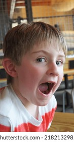 Happy And Excited Child In A Restaurant