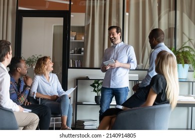 Happy excited diverse business group with male leader laughing on corporate meeting, feeling joy, stress relief during informal talk, sharing funny ideas, jokes, brainstorming. Teamwork, team success - Shutterstock ID 2140914805