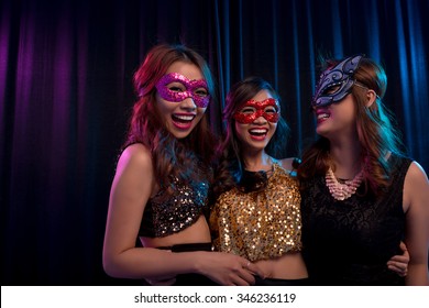 Happy excited girls wearing masquerade ball masks - Powered by Shutterstock