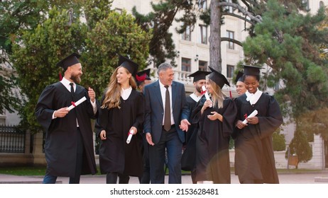 Happy And Excited Graduates Students Walking In Front Of Camera Together With The College Principal After The Graduation They Discussing All Together