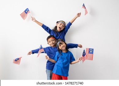 Happy Excited Malaysian Kids With Malaysia Flag Over White Background