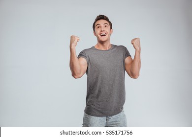 Happy Excited Man Screaming And Celebrating Succcess With Two Fists Up Over White Background