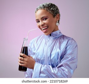 Happy, Excited And Portrait Of A Black Woman With A Soda In A Studio With A Purple Background. Stylish, Fashion And Young African Model With A Smile Drinking A Bottle Of Cola Beverage With A Straw.