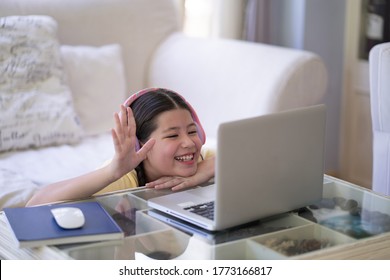 Happy Excited Pre Teen Studying On Computer Notebook, Stay At Home Stay Safe.  Waving At Computer Camera With Big Smile