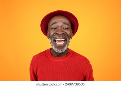 Happy excited senior african american man in hat and red clothes, with open mouth, look at camera, isolated on orange studio background, close up. Portrait, headshot for video call - Powered by Shutterstock