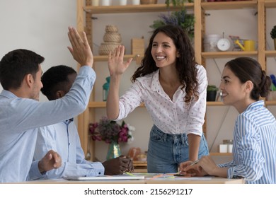 Happy excited two employees giving high five, celebrating team success, work achieve, sales result, thanking for successful idea, completing project, enjoying teamwork together - Shutterstock ID 2156291217