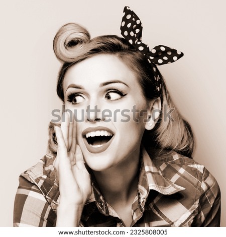 Happy excited woman holds hand near open mouth, looking aside saying something. Girl dressed in pinup style. Pin up model at retro fashion vintage concept. Brown toned monochrome bw photo.