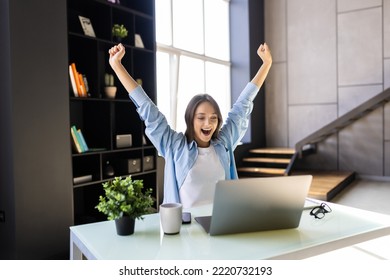 Happy Excited Woman At Home Workstation Triumphing With Raised Hands