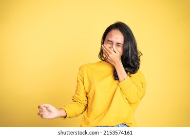 Happy Excited Woman Laughing Hard Cover Her Mouth Over Yellow Background