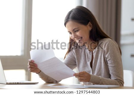 Happy excited woman student customer reading letter with good news, great cheap offer, get job opportunity, scholarship admission, loan approval, money refund holding paper mail bank statement