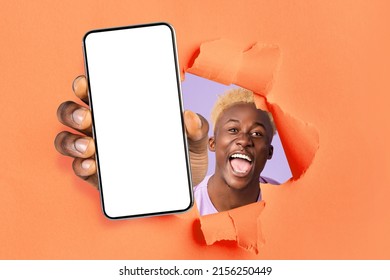 Happy Excited Young African American Guy Winner With Open Mouth Looks Through Hole In Orange Paper And Shows Smartphone With Empty Screen, Collage. Online Victory, Great Offer, App And New Technology