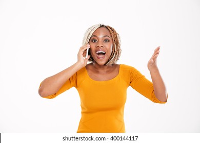 Happy Excited Young African American Woman Talking On Mobile Phone Over White Background