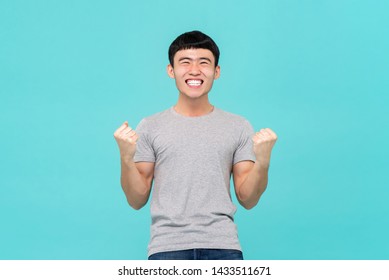 Happy Excited Young Asian Man Raising His Fists Doing Yes Gesture Celebrating Success
