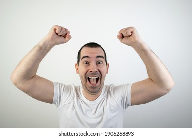 happy excited young male man stand closeup white background laugh hands up crazy look