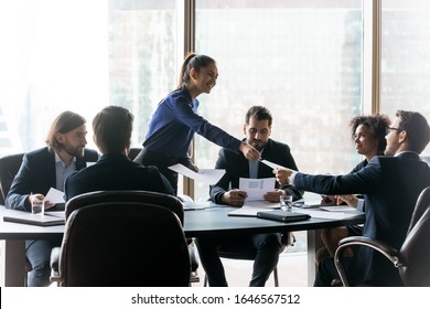 Happy Executive Businesswoman Manager Gives Handout In Boardroom At Meeting. Smiling Female Teacher Coach Lead New Project Presentation For Colleagues, Conversation At Negotiation, Discussing Results