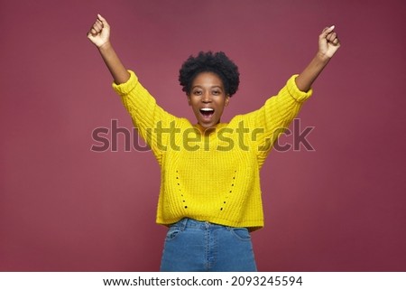 Happy exited african american girl champion rejoice success win, feel euphoric with achievement, shouting, raising hands