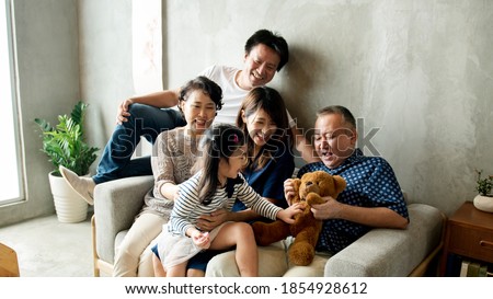 Happy extended Asian family spending time together
