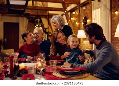 Happy extended family talking during Christmas dinner at dining table. - Powered by Shutterstock