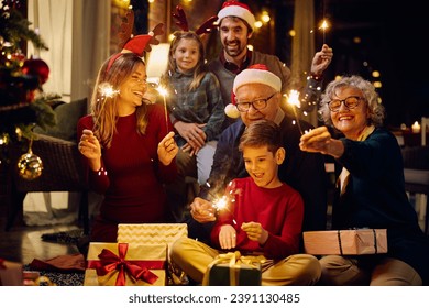 Happy extended family using sparklers and having fun while celebrating Christmas together at home. - Powered by Shutterstock