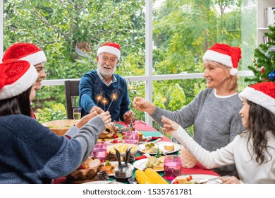 Happy Extended Multi Generation Family Having Dinner Together To Celebrate Christmas Holiday Together