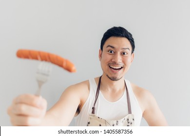 Happy Face Of Asian Man Proud To Eat And Cook Sausage. Concept Of Hate And Diet.