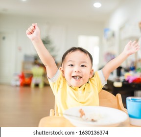 Happy Face And Enjoy Eating Concept.Little Asian Toddler Boy Raised Hands Enjoy Eating With Sticky Rice With Fork On A Plate In Breakfast Time At Home.Concept For Food, Child Development, Oral Health.