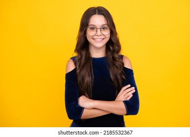 Happy Face, Positive And Smiling Emotions Of Teenager Girl. Confident Child Keep Arms Crossed, Isolated On Yellow Background, Empty Space. Little Caucasian Teenage Girl 12, 13, 14 Years Old Hold Hands