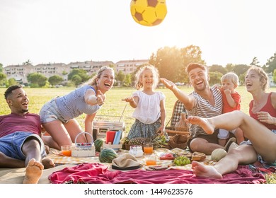 Happy families making picnic in city park - Young parents having fun with their children in summer time eating, laughing and playing together - Love and chlidood concept - Main focus on people faces - Powered by Shutterstock