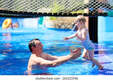 Happy Family, Active Father With Little Child, Adorable Toddler Girl, Having Fun Together In Outdoors Swimming Pool In Waterpark During Sunny Summer Sea Vacation In Tropical Resort. Focus On Kid