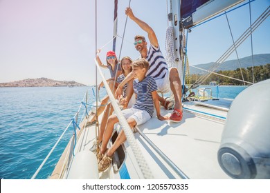 Happy family with adorable daughter and son resting on a big yacht